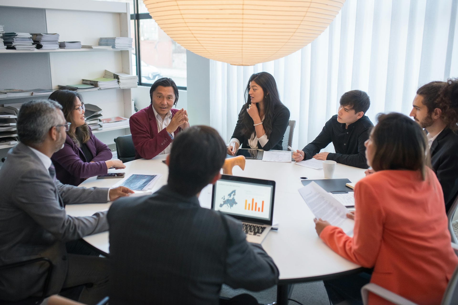 Diverse business team in strategy meeting around a conference table