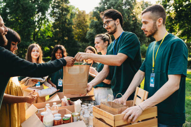Volunteers distributing food and supplies at a community outreach event